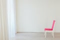 Pink vintage chair in the interior of an empty white room Royalty Free Stock Photo