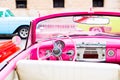 Pink vintage classic interior of American car parked on the street of Old Havana, Cuba Royalty Free Stock Photo