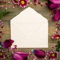 Pink and vintage paper envelope isolated on wood background. Flat lay, Top view. Royalty Free Stock Photo