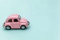 Pink vintage retro toy car isolated on blue pastel colorful background Royalty Free Stock Photo