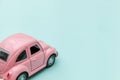 Pink vintage retro toy car isolated on blue pastel colorful background Royalty Free Stock Photo