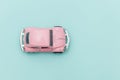 Pink vintage retro toy car isolated on blue pastel colorful background Royalty Free Stock Photo