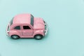 Pink vintage retro toy car isolated on blue pastel colorful background Royalty Free Stock Photo