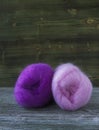 Pink and violet balls of mohair wool yarn for knitting, crochet on wooden rustic background Royalty Free Stock Photo