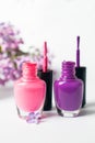 Pink and violet nail polish bottles on white background Royalty Free Stock Photo