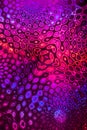 Pink-violet pattern like kaleidoscope on holographic paper.
