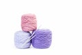 Pink and violet wool balls on a white background