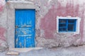 pink wall and blue old door Royalty Free Stock Photo