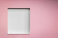Pink wall with window roller shutters closed with copy space Royalty Free Stock Photo