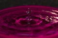 Pink water splash orb balanced on a water spike - stock photo