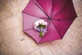 Pink wedding bouquet next to a red umbrella a rainy wedding day, nice melancholic photo Royalty Free Stock Photo