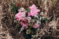 Pink wedding bouquet with a stone rose and peonies on the background of grass.