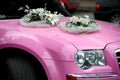 Pink wedding car with a bouquet of flowers Royalty Free Stock Photo