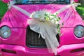 Pink wedding car with bouquet of flowers Royalty Free Stock Photo