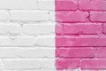 Pink and white brick wall detail texture background. Old, painted, weathered and cracked bricks with concrete and stucco Royalty Free Stock Photo