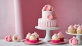 pink and white cake and cupcakes on a table