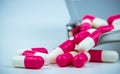 Pink-white capsule pills on stainless steel drug tray. Pharmacy drugstore. Pharmaceutics concept. Pharmaceutical industry. Pills.