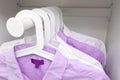 Pink and white classic man`s shirts on hangers in a wardrobe Royalty Free Stock Photo