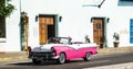 Pink and white convertible on a road in Havana Cuba Royalty Free Stock Photo