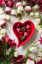 Pink and white flowers with chocolate candies heart shape Royalty Free Stock Photo