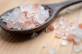 Pink and white himalayan salt on wooden table