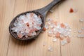 Pink and white himalayan salt on wooden table