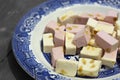 Pink and white nougat with peanuts on a blue and white plate Royalty Free Stock Photo