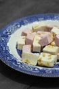 Pink and white nougat with peanuts on a blue and white plate Royalty Free Stock Photo