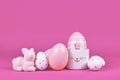 Pink and white painted easter eggs and cute easter egg cup in shape of bunny Royalty Free Stock Photo