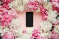 Pink and white peonies and phone with blank screen on pastel pink paper. Stylish flat lay with copy space. Happy mothers day, Royalty Free Stock Photo