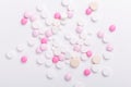 Pink and white pills on white background. Heap of assorted various medicine tablets and pills. Health care Royalty Free Stock Photo