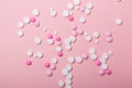 Pink and white pills on pink background. Heap of assorted various medicine tablets and pills. Health care Royalty Free Stock Photo