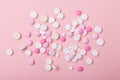 Pink and white pills on pink background. Heap of assorted various medicine tablets and pills. Horizontal banner Royalty Free Stock Photo