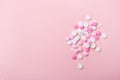 Pink and white pills on pink background Heap of assorted various medicine tablets and pills Royalty Free Stock Photo