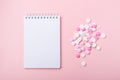 Pink and white pills on pink background Notebook Heap of assorted various medicine tablets and pills Royalty Free Stock Photo