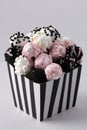 Pink and white popcorn and marshmallow treats in striped box Royalty Free Stock Photo
