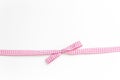 Pink and white rips textile ribbon with bow on white background Royalty Free Stock Photo