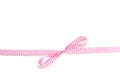 Pink and white rips textile ribbon with bow on white background Royalty Free Stock Photo