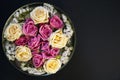 Pink and white roses and limonium in a bowl with water on a black background Royalty Free Stock Photo