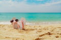 Pink and white sandals, sunglasses on sand beach at seaside. Casual fashion style flipflop and glasses. Summer vacation. Royalty Free Stock Photo