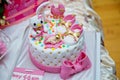 Pink and white theme cake for baby . newborn boy birthday cake . Children`s shoes . It`s a boy baby shower cake Royalty Free Stock Photo