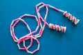 Pink and White Toy Jump Rope on a Blue Background Royalty Free Stock Photo
