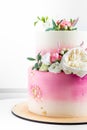 Pink and white wedding bunk cake with fresh flowers decoration Royalty Free Stock Photo