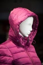 pink winter coat on mannequin in a fashion store showroom for women