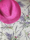 pink women\'s hat on a beautiful Provence-style tablecloth on the table. free space for text