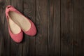 Pink women`s shoes ballerinas on wooden background. Royalty Free Stock Photo