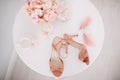 Pink women shoes, a bouquet of spring flowers and marshmallows on white background. Morning of the bride. flat lay Royalty Free Stock Photo