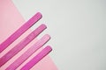 Pink wood ice-cream stick isolated on pink and white background Royalty Free Stock Photo