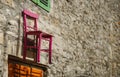 Pink wooden chair on old stone wall of house, Biograd na Moru in Croatia Royalty Free Stock Photo