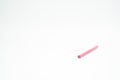 Pink wooden colored pencil on a white background with end part in focus Royalty Free Stock Photo